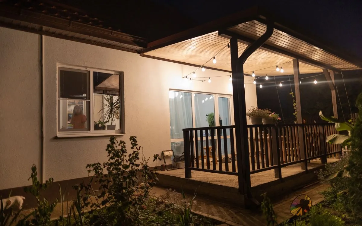 House at night with the porch lights and string lights still on