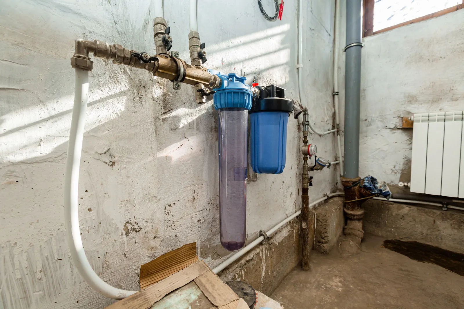 Two whole-house filter housings plumbed into the main water line