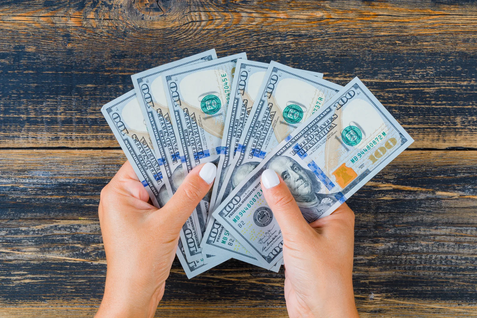 Hands counting US dollar bills