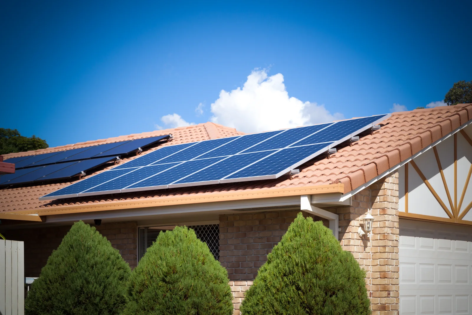 Solar panels generating power on a residential roof
